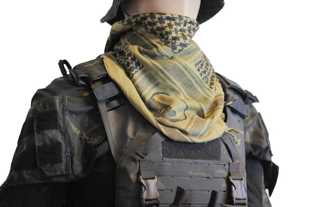 A person wearing a camouflage tactical military scarf colour Black/Coyote on their head and neck.