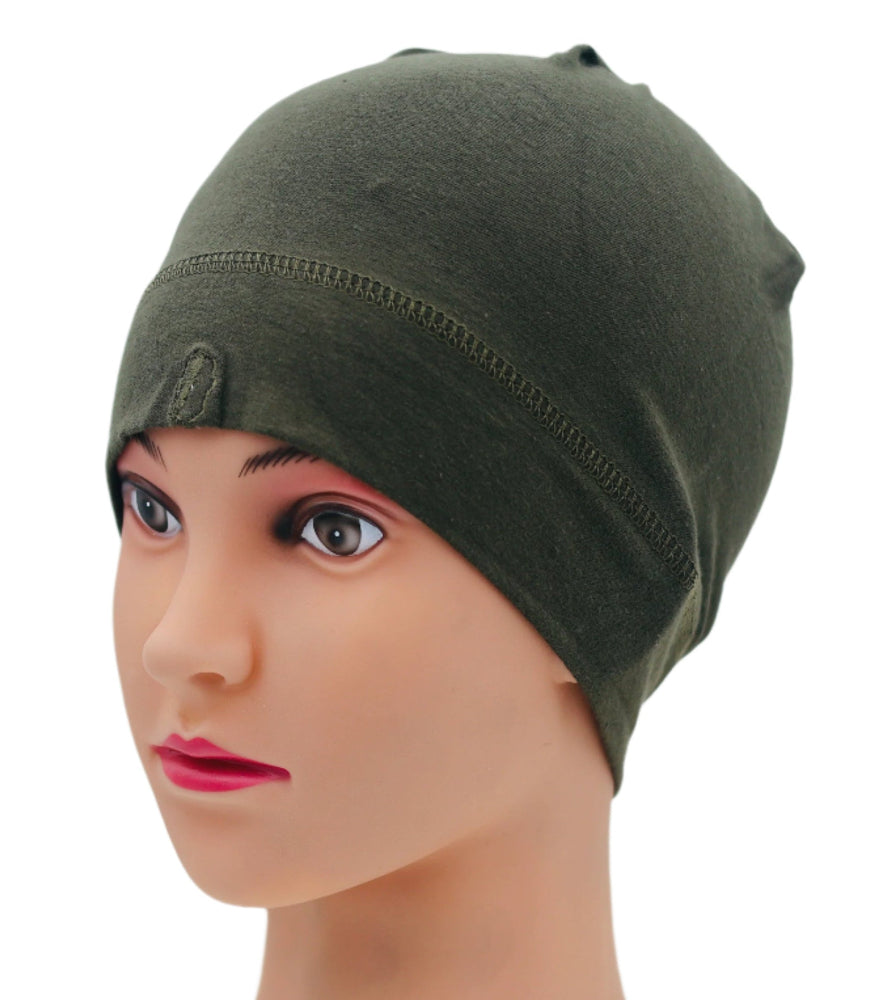 Green under helmet beanie on a mannequin head against a white background