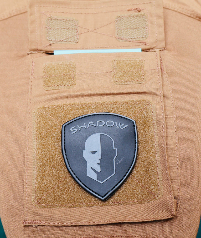 Arm Pocket of Combat T shirt and Tactical patch with 'Shadow' logo on a tan background