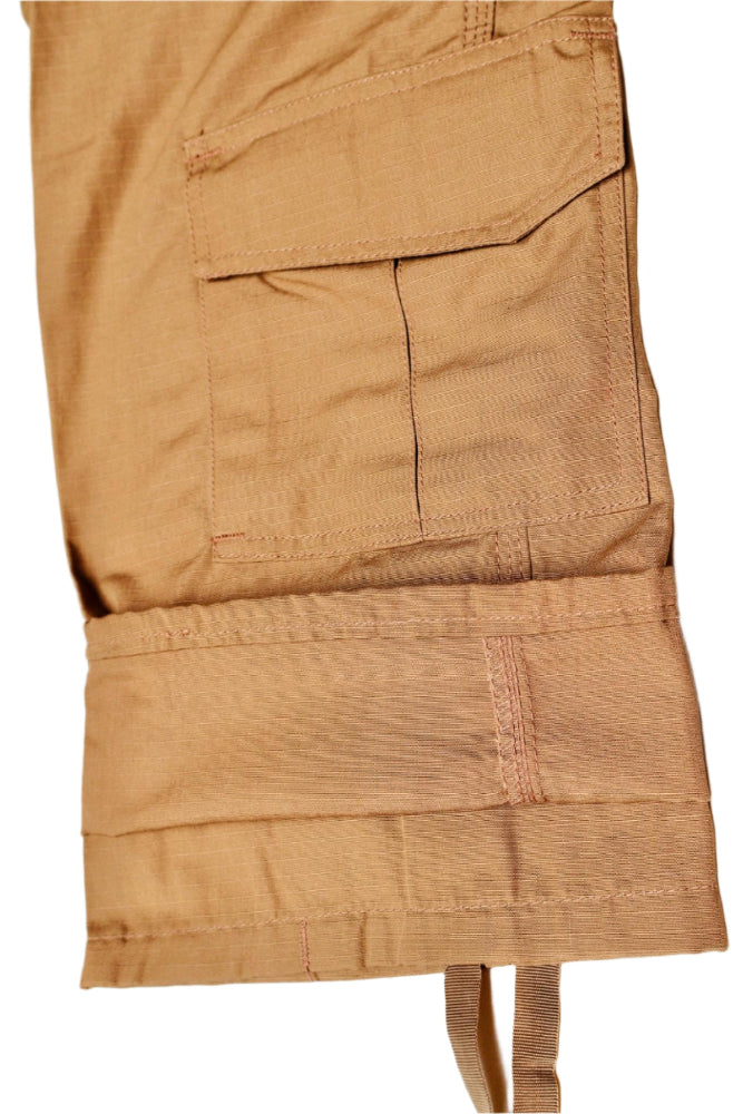 Close-up of brown cargo Pants close up let with multiple pockets on a white background by Shadow Strategic