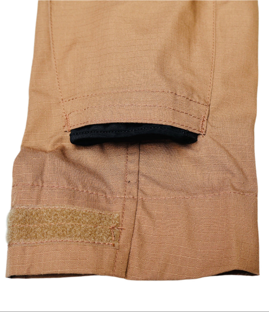 Close-up of a removable elbow pad on Coyote brown Combat shirt Arm  on a white background