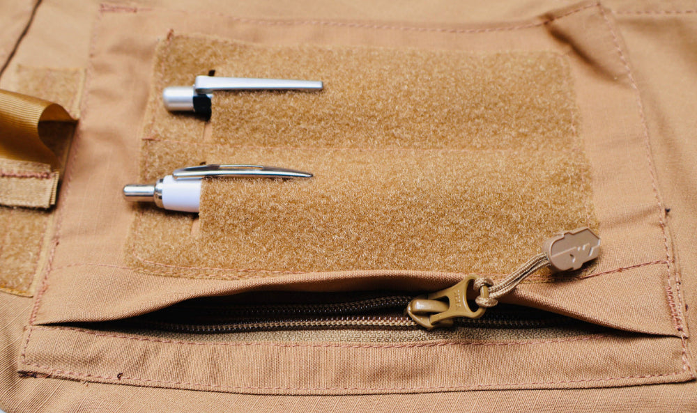 Close-up of a brown tactical pocket with various components attached on Shadow Strategic BDU Shirt shoulder pocket with YKK Zipper.
