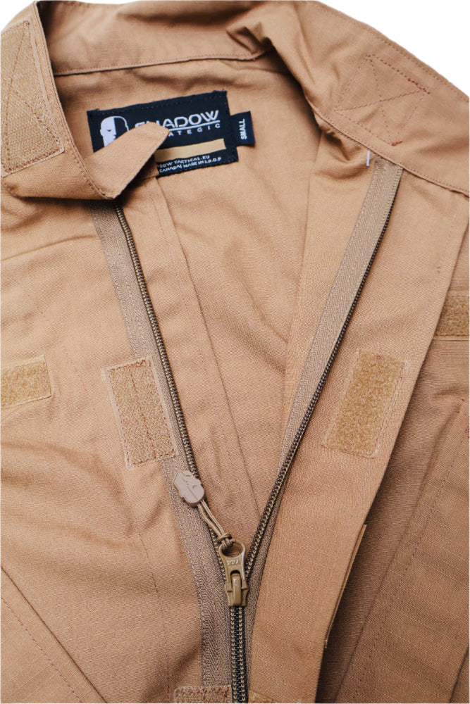 Close-up of a Coyote brown BDU Shirt with a brand label and YKK Zipper by Shadow Strategic on a white background
